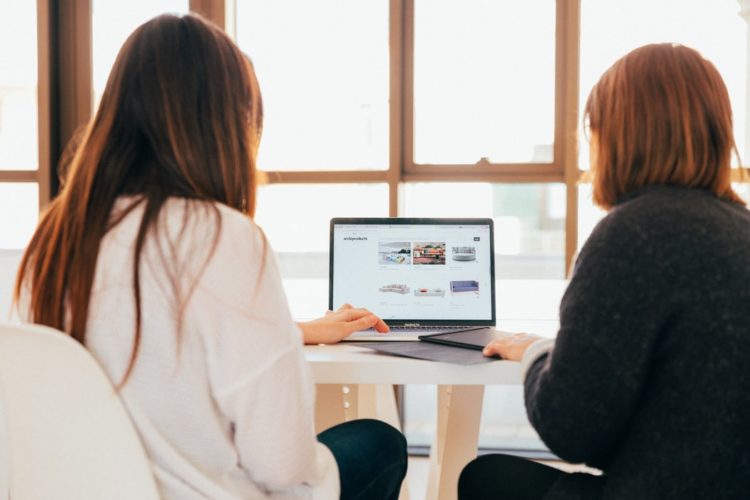 Two women browsing content for their website